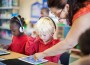 Teacher helping student with iPad